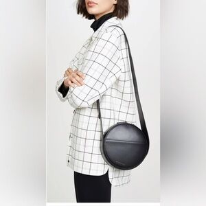 Want Les Essentiels Nikos round leather crossbody bag in black and navy